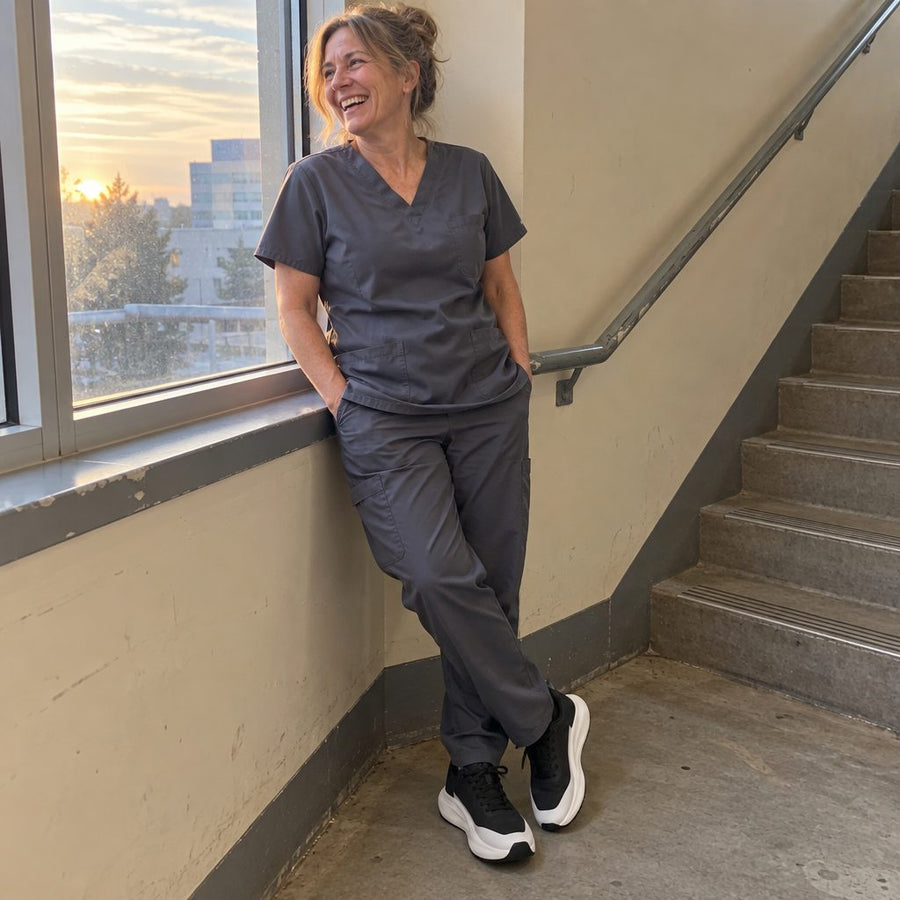 Nurse in scrubs and UOVO Breeze sneakers in a hospital stairwell