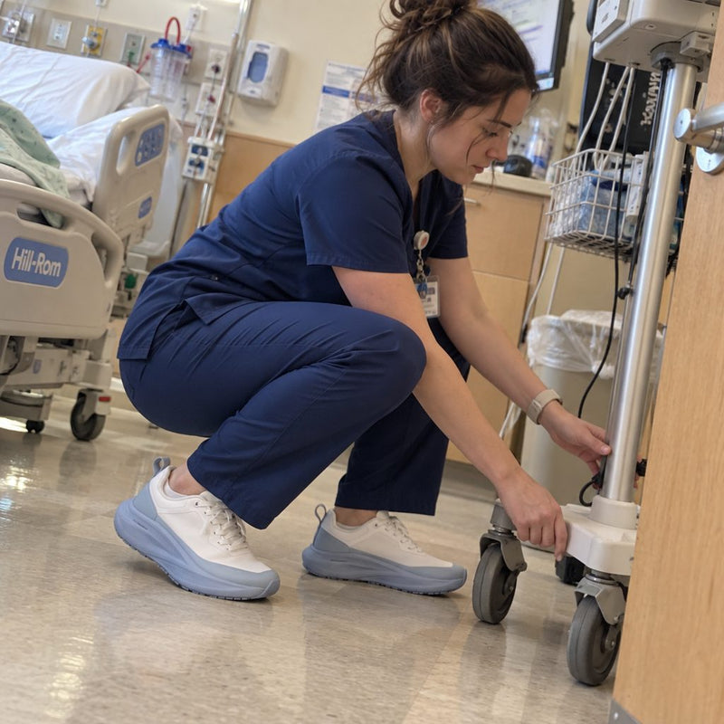 Nurse crouching at a patient's bedside