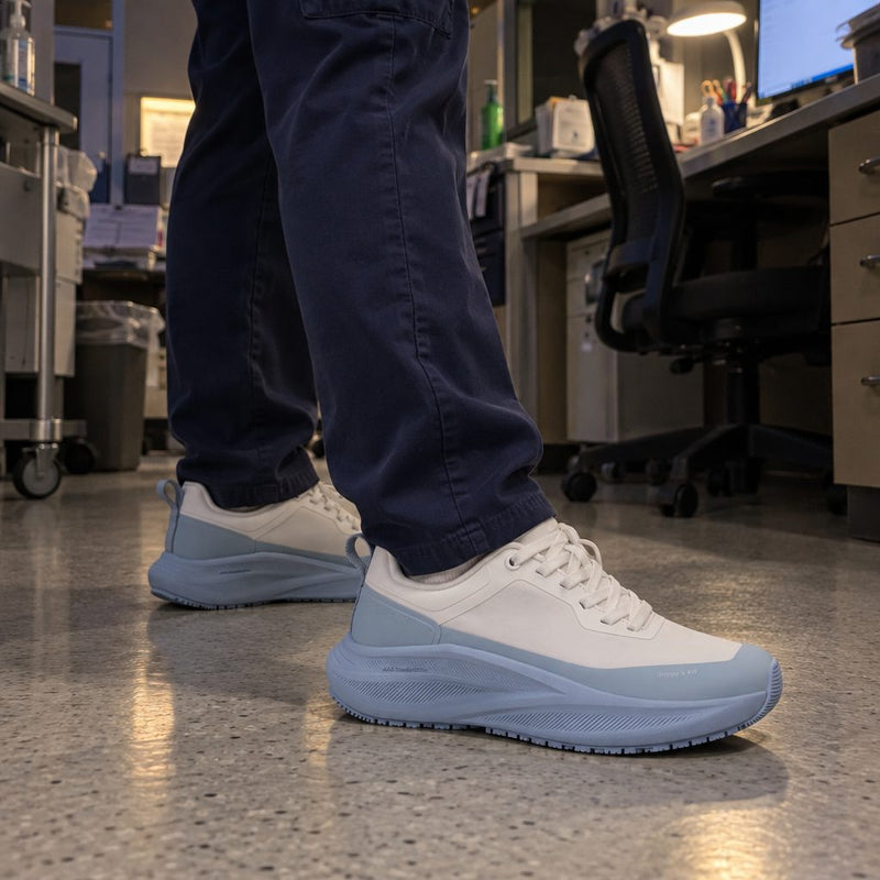Close-up of a nurse's Breeze sneakers at a nurses' station