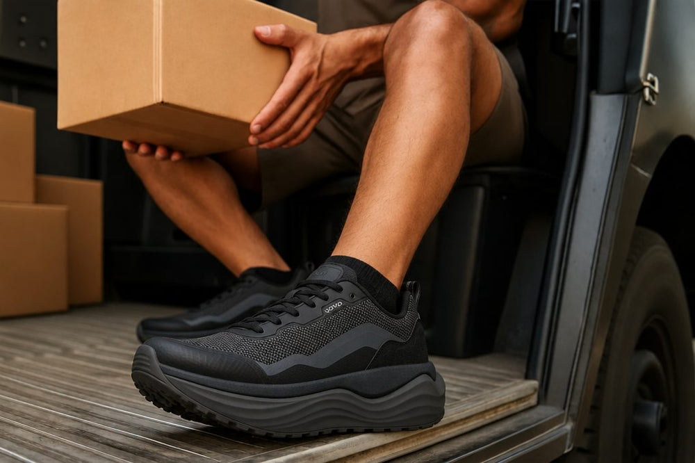 Delivery driver in black sneakers stepping out of a van with a box